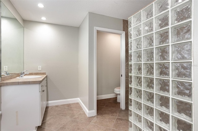 bathroom featuring tile patterned flooring, vanity, and toilet