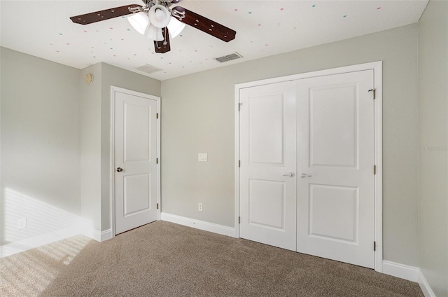 unfurnished bedroom with carpet flooring, ceiling fan, and a closet