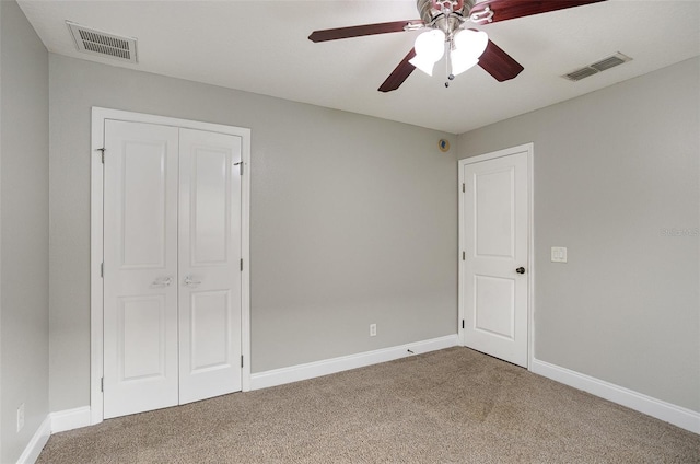 unfurnished bedroom with ceiling fan, carpet floors, and a closet