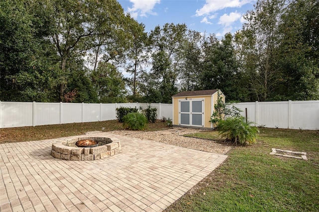 view of patio with an outdoor fire pit and a storage shed