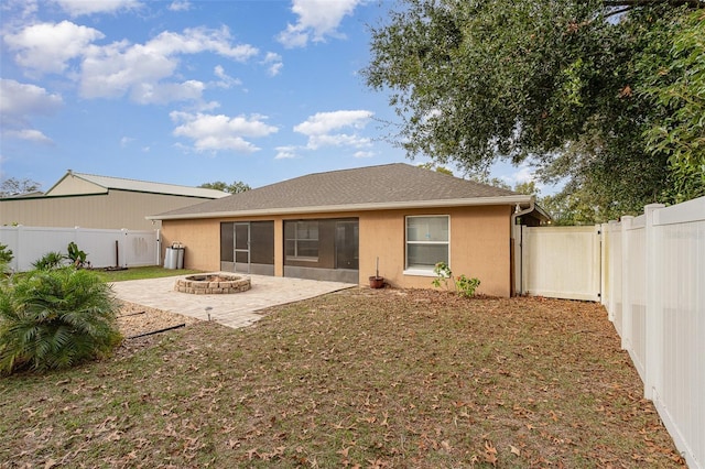 rear view of house featuring a patio area and an outdoor fire pit