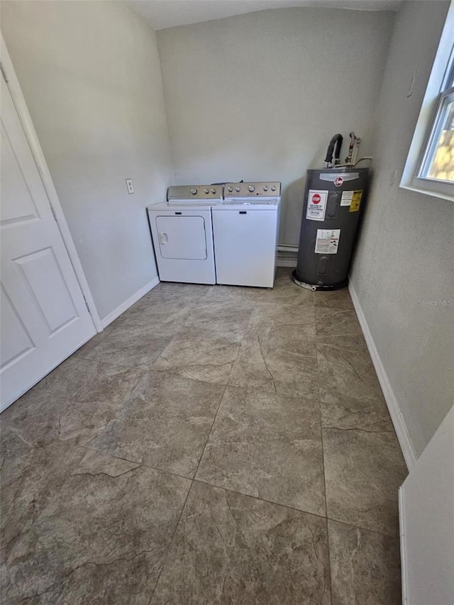 laundry room with separate washer and dryer and water heater