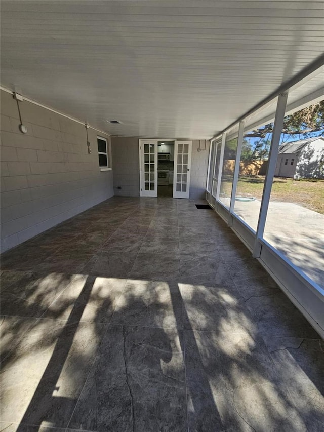 unfurnished sunroom with french doors