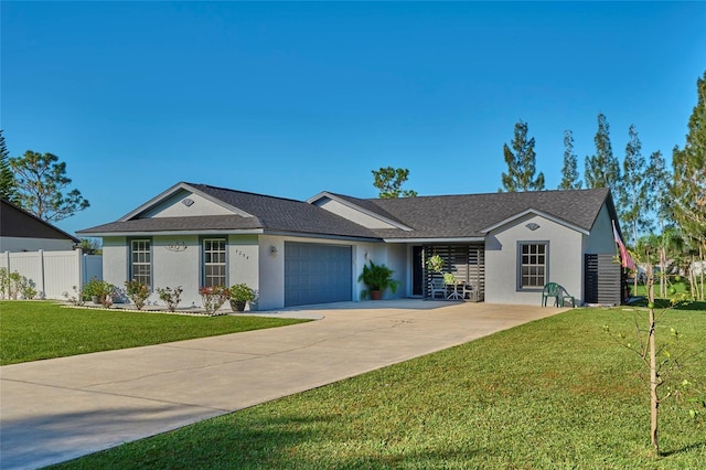 ranch-style house featuring a garage and a front lawn