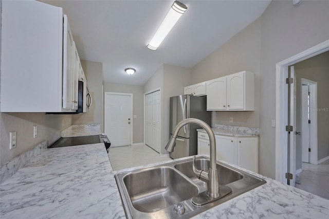 kitchen featuring white cabinets, lofted ceiling, sink, and stainless steel appliances