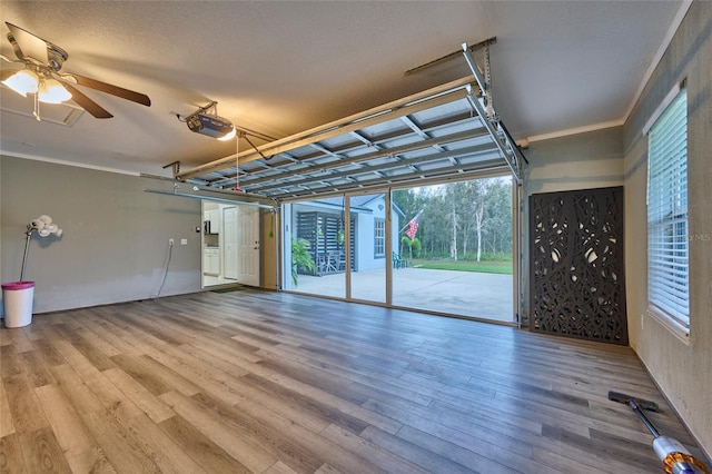 garage with a garage door opener and ceiling fan