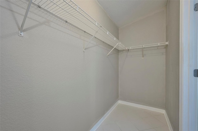 spacious closet featuring tile patterned flooring