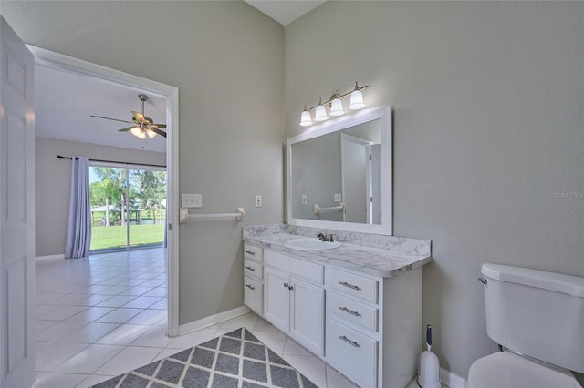 bathroom featuring toilet, vanity, tile patterned floors, and ceiling fan