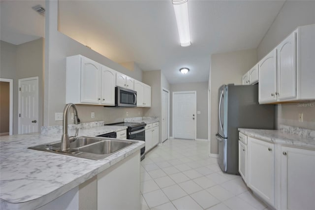 kitchen featuring sink, white cabinetry, stainless steel appliances, and light tile patterned floors