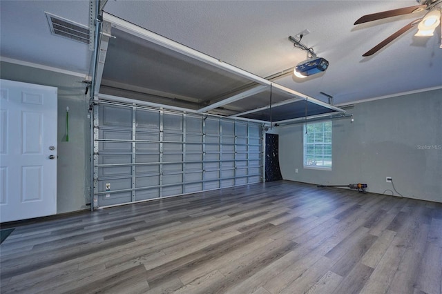 garage featuring ceiling fan and a garage door opener