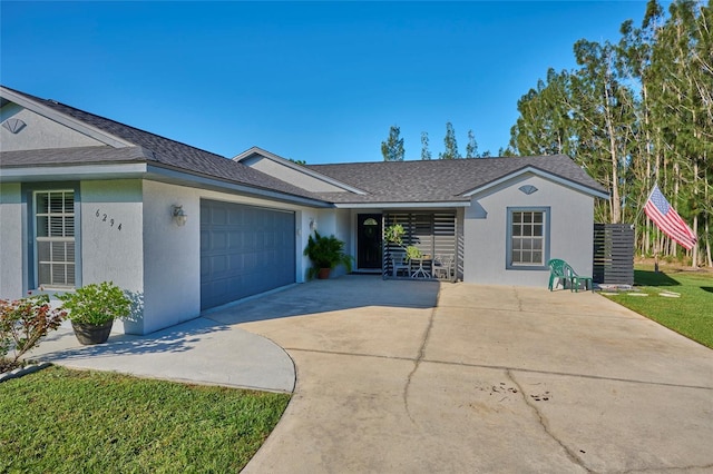 single story home with a garage and a front lawn