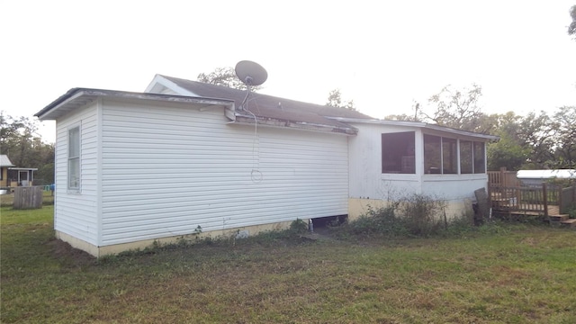 view of side of home with a yard