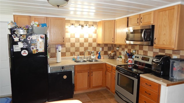 kitchen featuring light tile patterned flooring, sink, appliances with stainless steel finishes, and tasteful backsplash