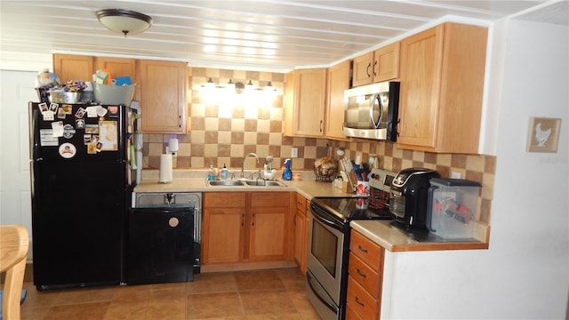 kitchen featuring light tile patterned floors, sink, tasteful backsplash, and black appliances