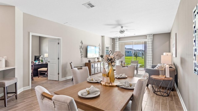 dining area featuring a textured ceiling, light hardwood / wood-style floors, and ceiling fan