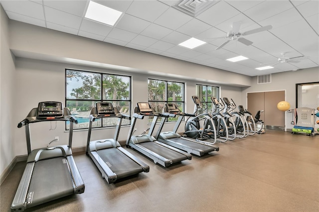 exercise room with a paneled ceiling and ceiling fan