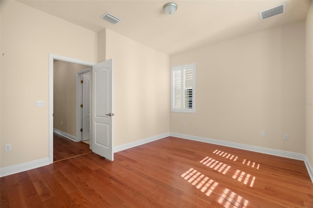 empty room featuring hardwood / wood-style flooring