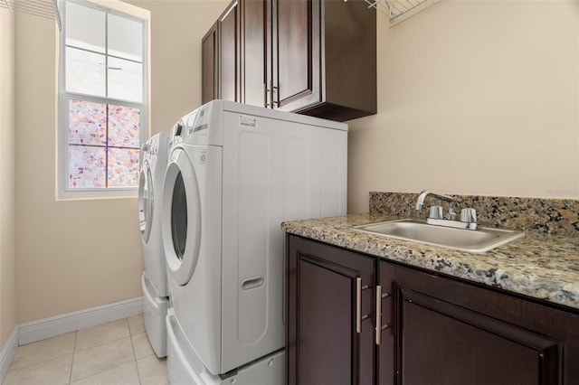 washroom featuring washer and dryer, plenty of natural light, cabinets, and sink