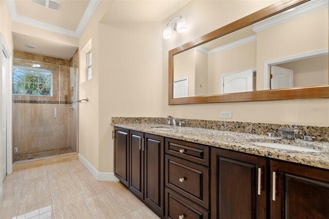 bathroom featuring tile patterned floors, vanity, an enclosed shower, and ornamental molding