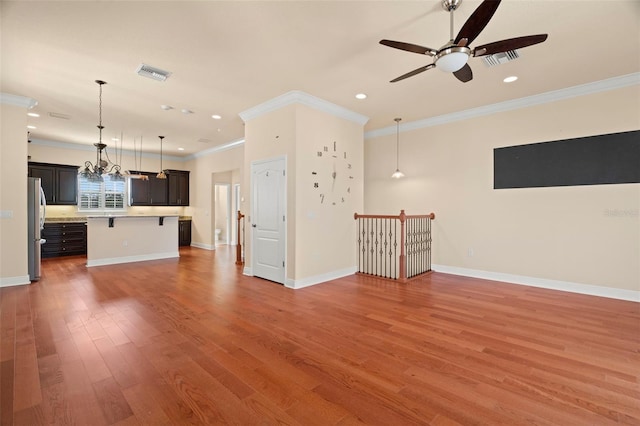 562 Rivercrest Ln, Tarpon Springs, FL 34689 - unfurnished living room with a ceiling fan, crown molding, recessed lighting, wood finished floors, and baseboards