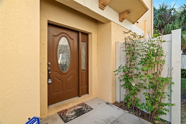 562 Rivercrest Ln, Tarpon Springs, FL 34689 - property entrance featuring stucco siding