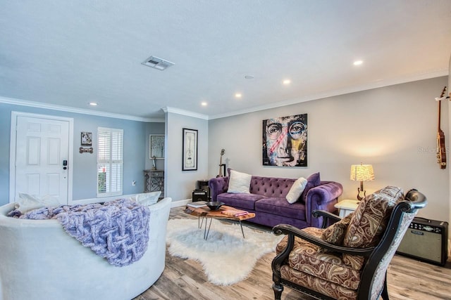 living room with crown molding and light hardwood / wood-style flooring