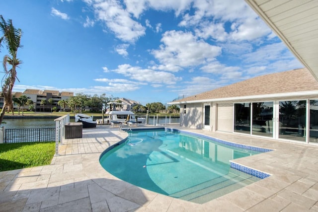 view of swimming pool with a patio area and a water view