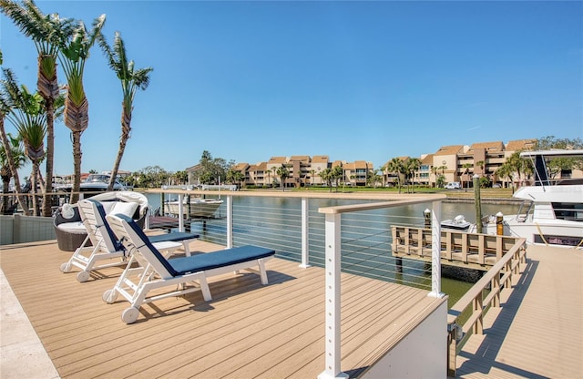 dock area with a water view and a residential view