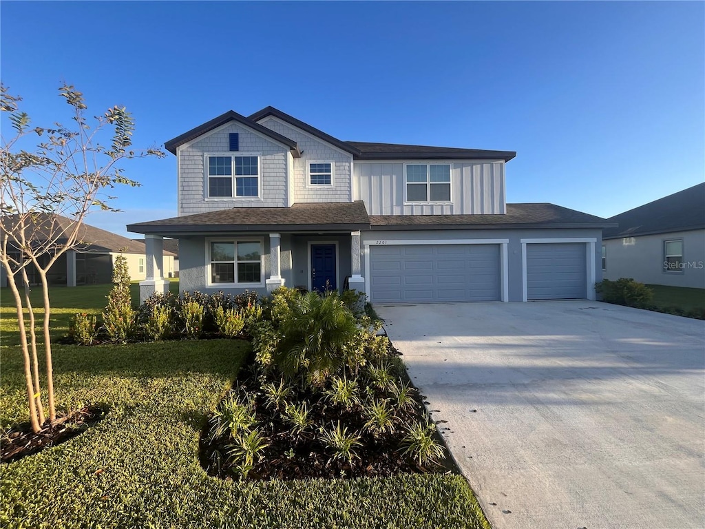 view of front facade featuring a front yard and a garage