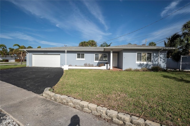 ranch-style house featuring a front yard and a garage