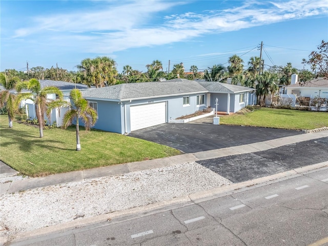 single story home with a front yard and a garage