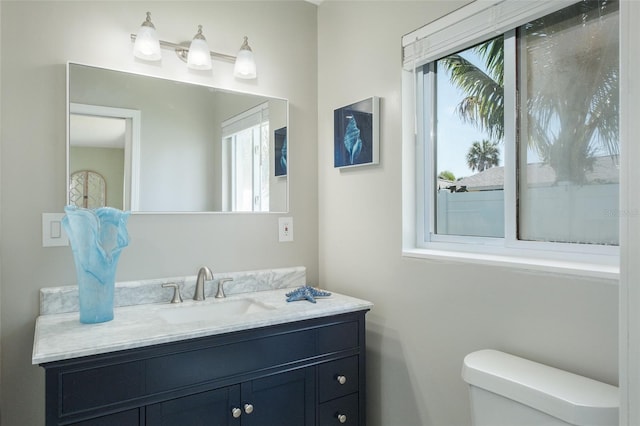 bathroom featuring vanity and toilet