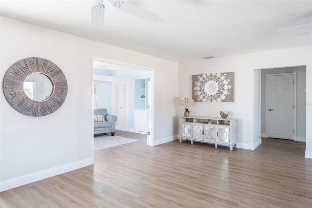 interior space with ceiling fan and hardwood / wood-style flooring