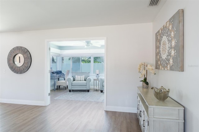 hallway with light hardwood / wood-style floors