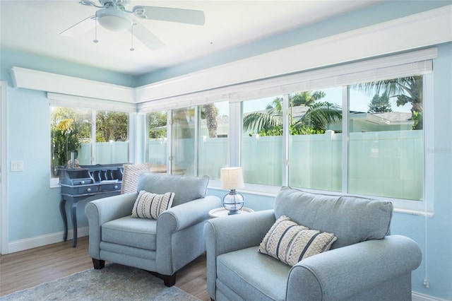 sunroom featuring ceiling fan and a wealth of natural light