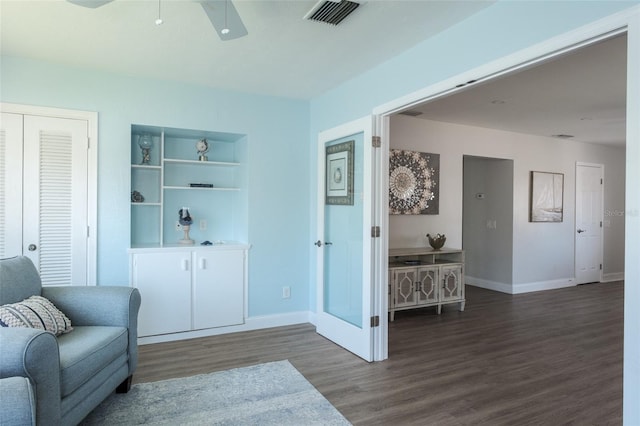 sitting room featuring dark hardwood / wood-style flooring and ceiling fan