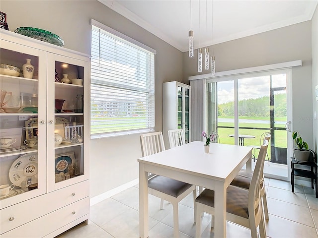 dining room with light tile patterned floors and ornamental molding