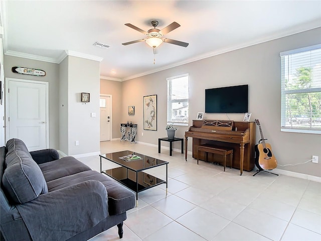 tiled living room with ceiling fan and crown molding