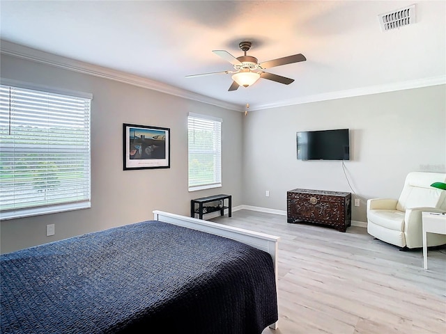 bedroom featuring light hardwood / wood-style floors, ceiling fan, and ornamental molding