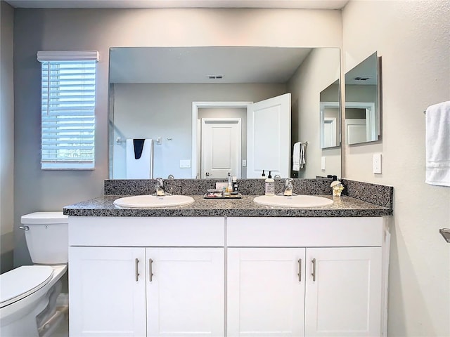 bathroom with vanity and toilet