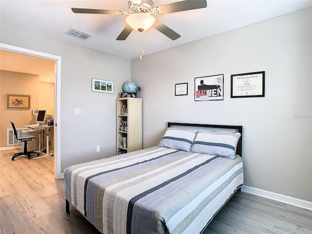 bedroom with ceiling fan and wood-type flooring