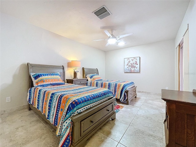 tiled bedroom featuring ceiling fan