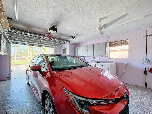 garage featuring ceiling fan, a garage door opener, and washing machine and clothes dryer