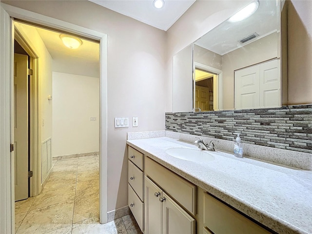 bathroom with tasteful backsplash and vanity