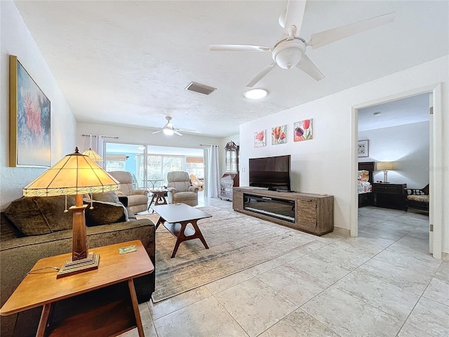 tiled living room with ceiling fan