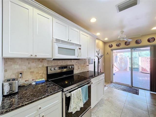 kitchen featuring white cabinets, electric stove, backsplash, and dark stone counters