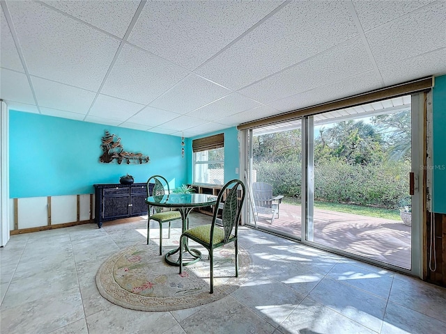 dining area with a drop ceiling