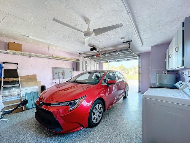 garage featuring ceiling fan, independent washer and dryer, and a garage door opener