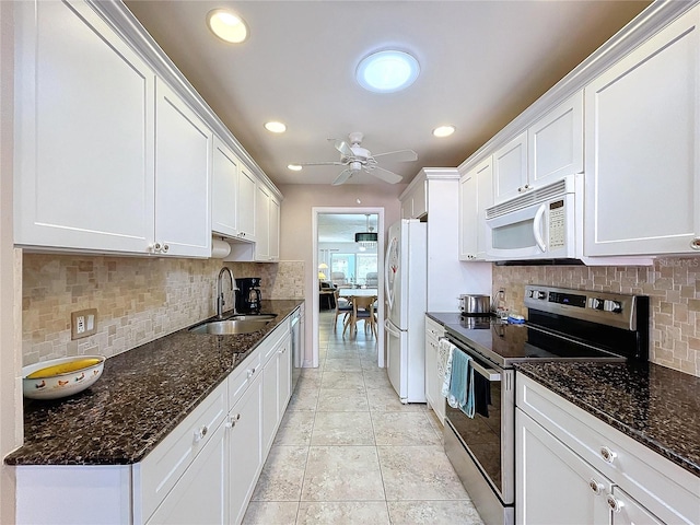 kitchen with tasteful backsplash, white cabinetry, sink, and appliances with stainless steel finishes