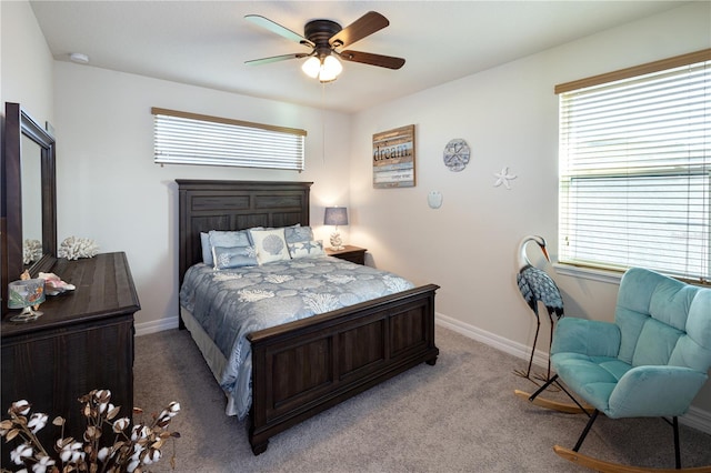 carpeted bedroom featuring ceiling fan and multiple windows